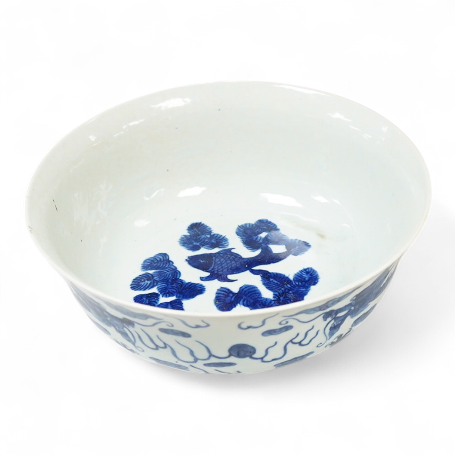 A Chinese blue and white dragon bowl, Kangxi mark but later, 26cm diameter